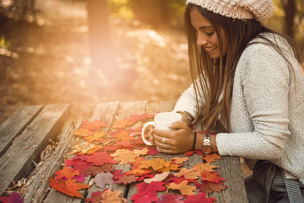 cheerful woman with mug table autumn part